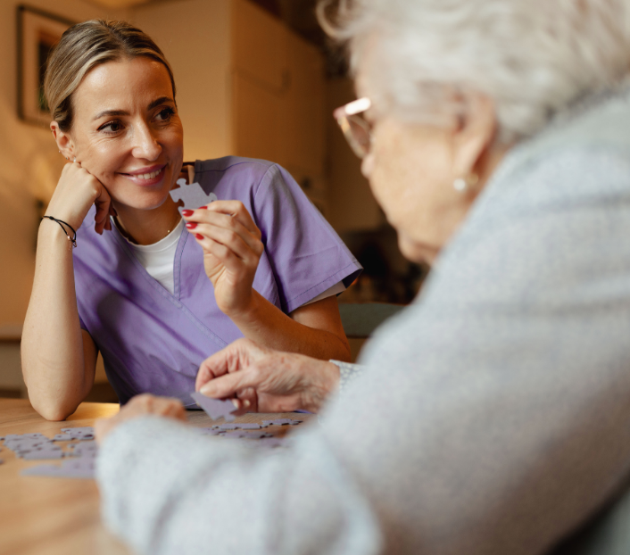 Saxon Care worker providing home care in chippenham with a client completing a puzzle together